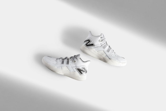 Side view of Coco Gauff's white and black New Balance tennis shoes.